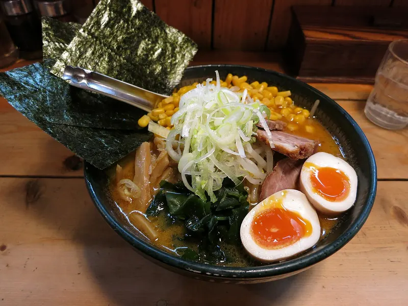 Cuenco de ramen con huevo, maíz, alga y cebolleta